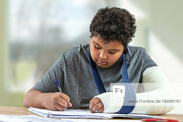 Young boy in tran doing his homework