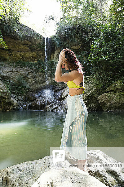 Solo Woman in a bikini with towel at a waterfall in Puerto Rico