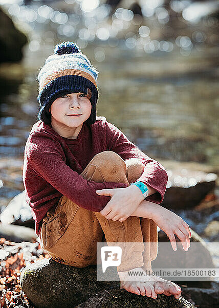 Portrait of young boy on rocks in nature