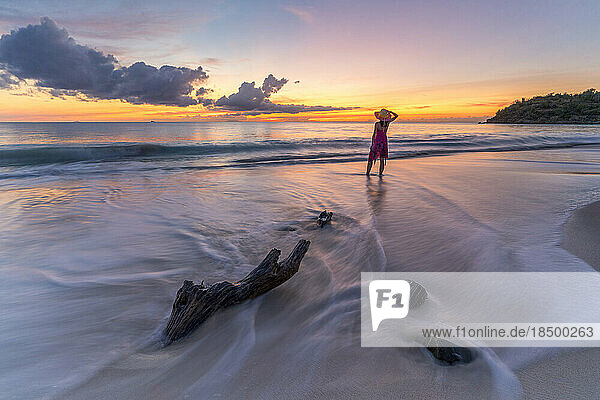 Woman enjoying sunset on tropical beach  Caribbean Sea  Antilles