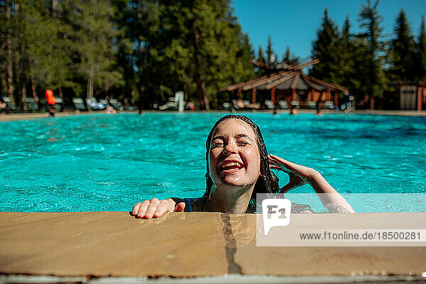 Happy teen girl on side of pool