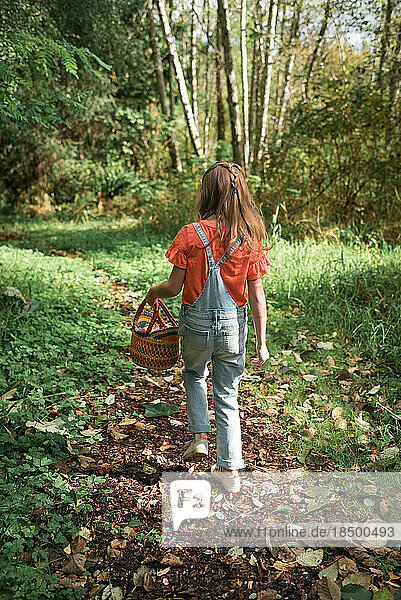 Girl Walking in woods with basket