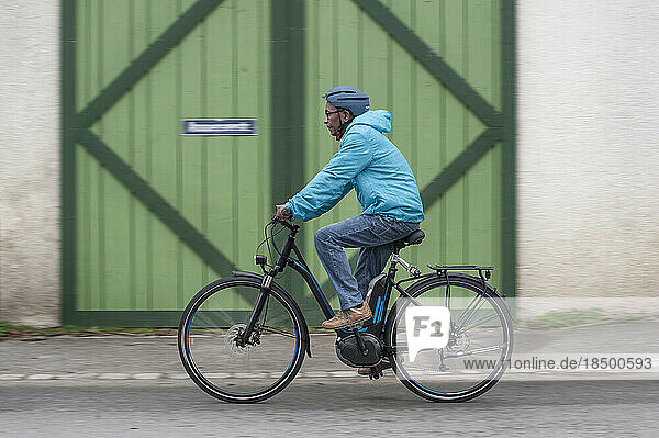 Senior man with cycling helmet on his bicycle  Bavaria  Germany
