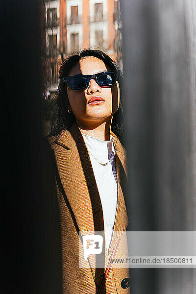 portrait of asian girl illuminated by the sun with shadows outdoors