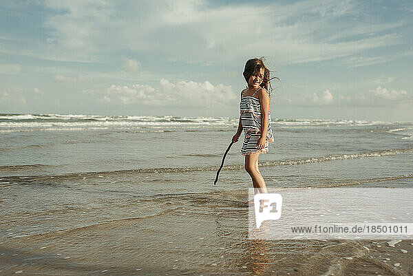 Girl standing in ocean at the beach in Corpus Christi Texas