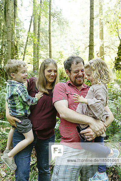 Closeup portrait of a family laughing together on a forest hike
