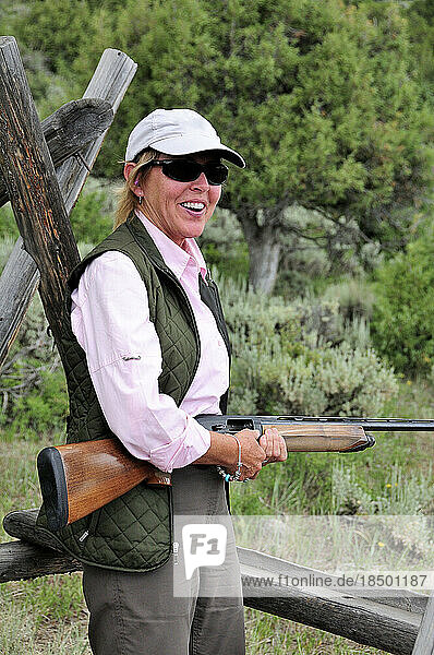 A woman shoots sporting clays in the mountains of Colorado