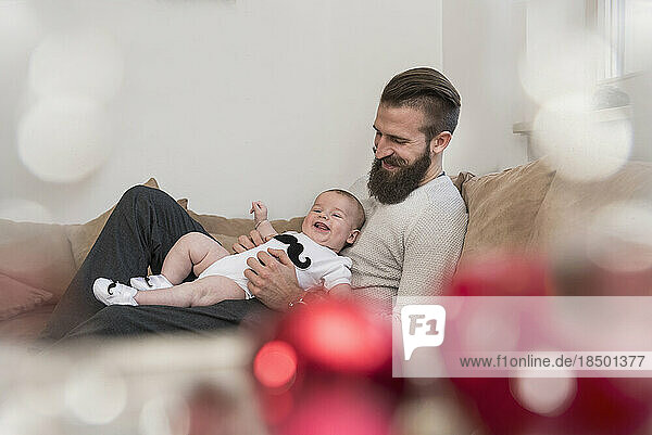 Father with son lying on sofa