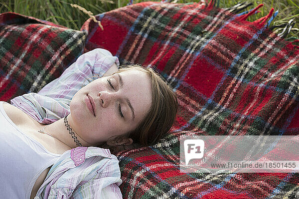 Close-up of a young woman sleeping on blanket  Bavaria  Germany