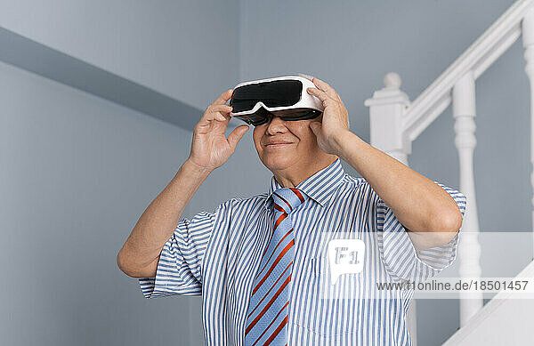 Senior man having experience virtual reality with VR headset device