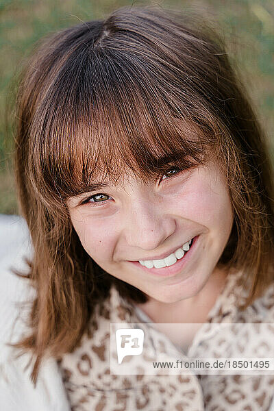 Vertical portrait of a smiling caucasian teenage girl 12 years o