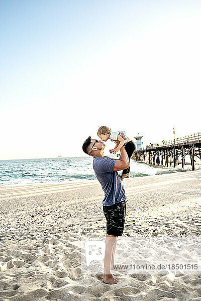 Dad kissing daughter at beach