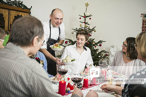 Family enjoying Christmas dinner at home