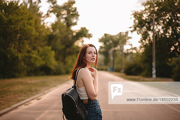 Young woman walking on country road