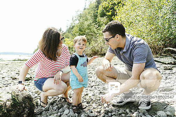 Straight on portrait of a family together on a rocky beach