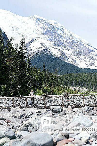 Hiker is standing on the bridge at Mt Rainier National Park