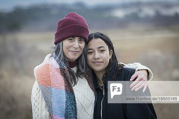 portrait of white mother with biracial teen daughter in nature