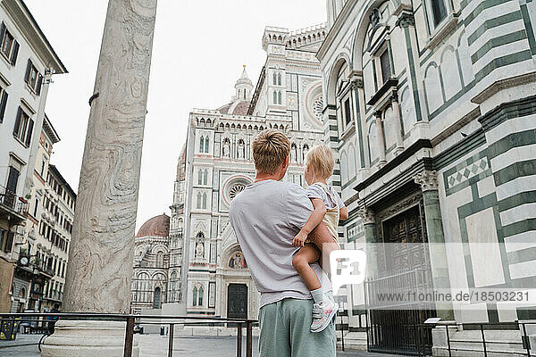 A young father with a baby visits Florence  a trip to Italy with kids