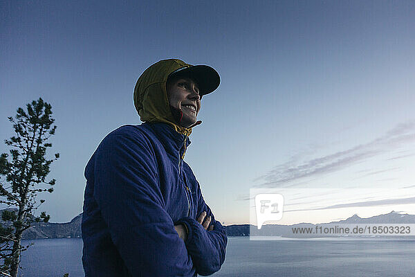 A woman smiles while enjoying Crater Lake National Park in Oregon.