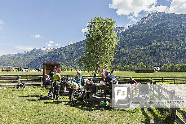 Group of friends preparing for rock climbing  Otztal  Tyrol  Austria