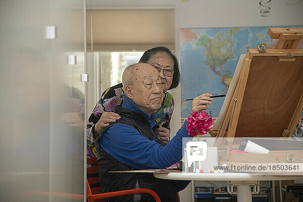 Senior retiree painting in the afternoon