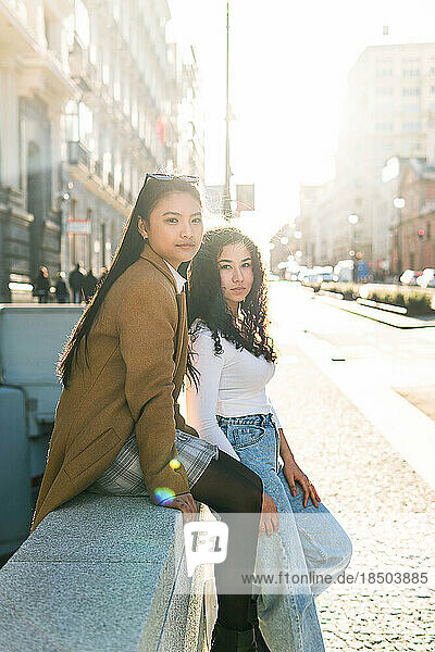 Stock photo of two friends with sunlight. Models posing