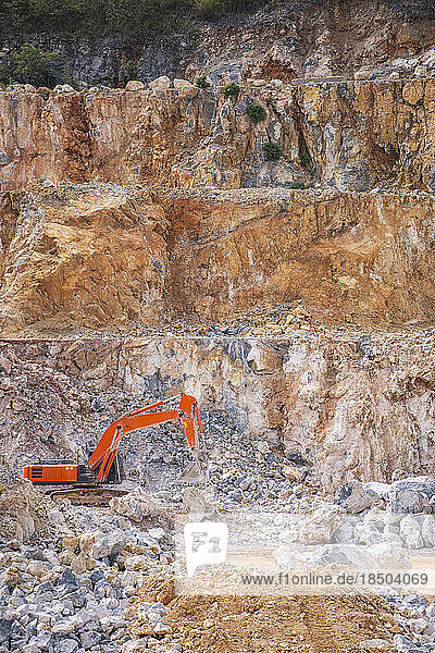 excavator working at gravel mine in Thailand