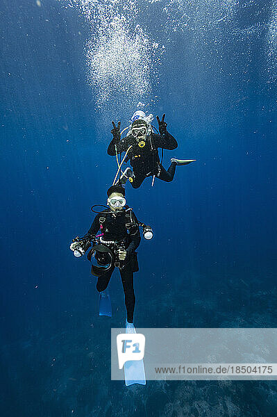 couple sharing air in the clear waters of the Gulf of Thailand