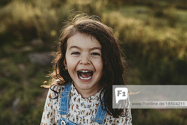 Funny portrait of young school-aged girl with sunlight in her hair