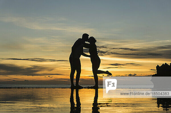 Silhouette of couple kissing during sunset on beach  Nusa lembongang  Bali  Indonesia
