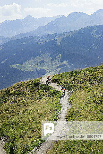 Elevated view of mountain bikers riding on uphill  Zillertal  Tyrol  Austria