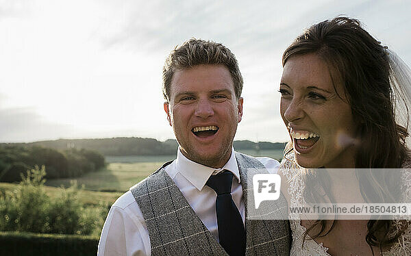 Newly married couple  bride and groom laughing on their wedding day