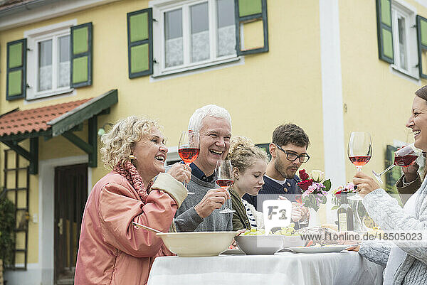 Family and friends enjoying outdoor party at farmhouse  Bavaria  Germany