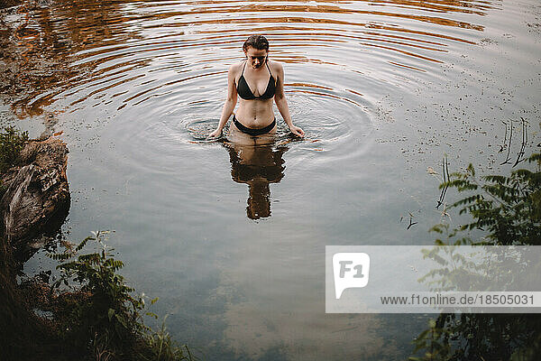 Young seductive woman in water