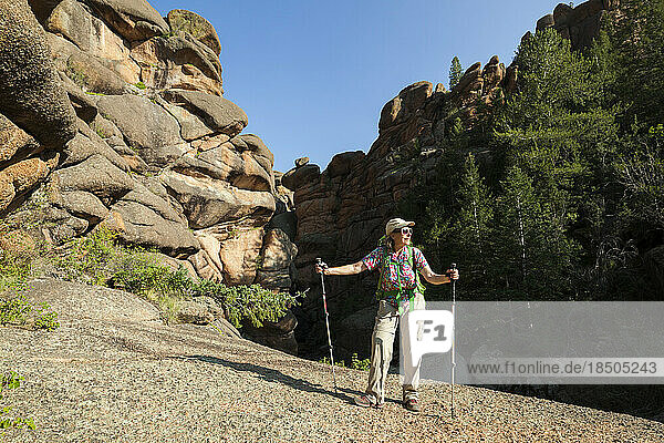 Senior woman hiker among rock formations in Lost Creek Wilderness