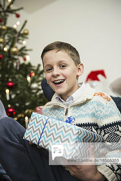 Portrait of boy with Christmas present