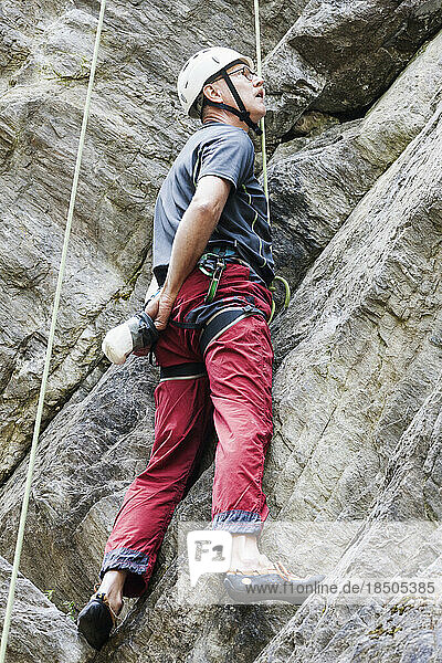 Male climber scaling rock face  Sautens  Otztal  Tyrol  Austria