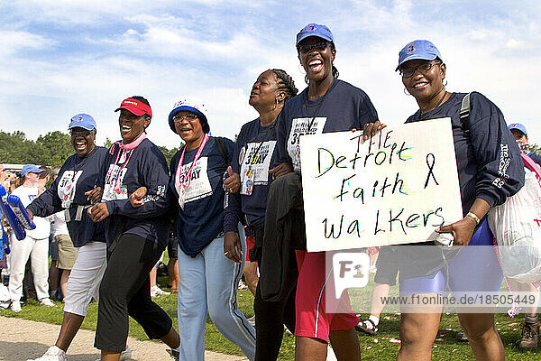 Members of the walker team The Detroit Faith Walkers walk in the parade during closing ceremonies of the Komen Breast Cancer 3-D
