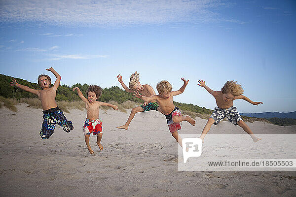 Group of kids jumping on the beach  Viana do Castelo  Norte Region  Portugal