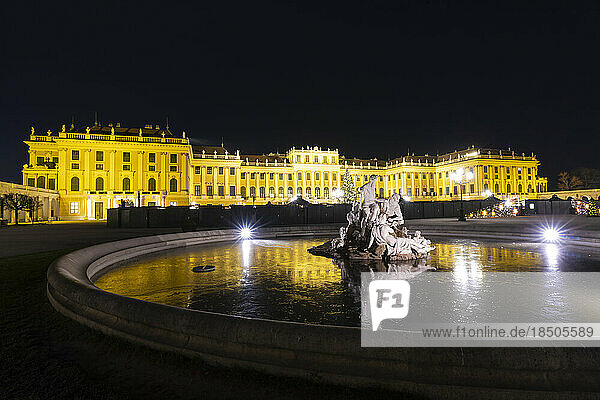 Naiad Fountain in front of the illuminated Schonbrunn Palace  Vienna