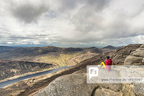 Woman sit on top of the Slieve Binnian Mountains