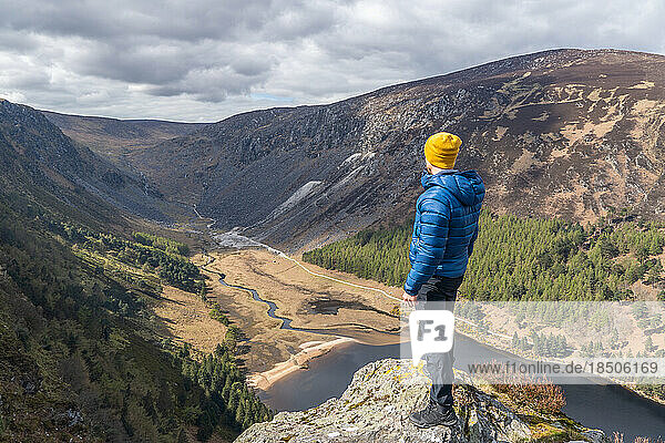 Hiker man enjoying the scenery in glendalough ireland