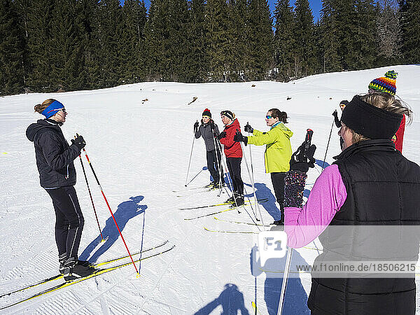 Participants learning cross country skiing course with female teacher  Black-Forest  Baden-Württemberg  Germany