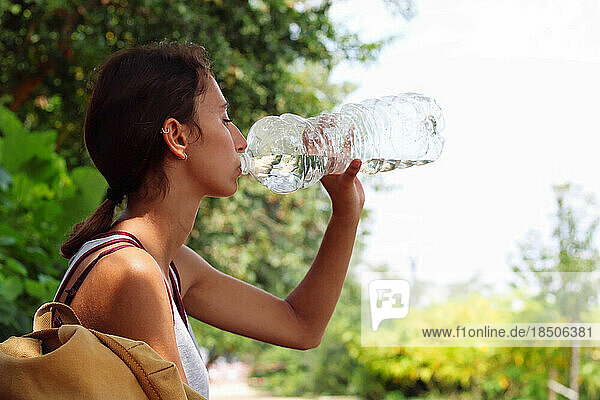 Young and beautiful girl drinking water.