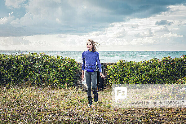 Dramatic Seascape and Young Girl Walking