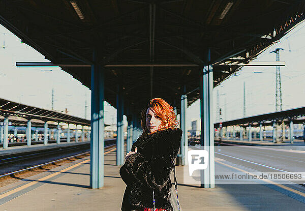 red-haired woman in train station