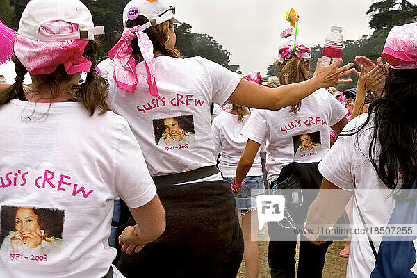 A walker team named Susi's Crew gets high fives at a breast cancer walk in San Francisco.
