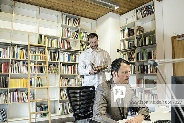 Two businessmen working in an office  Bavaria  Germany