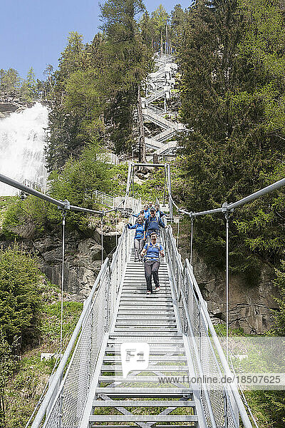 Group of climbers walking through suspension stairway  Stuibenfall Waterfall  Otztal  Tyrol  Austria