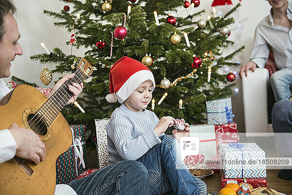 Boy unwrapping chocolate during Christmas